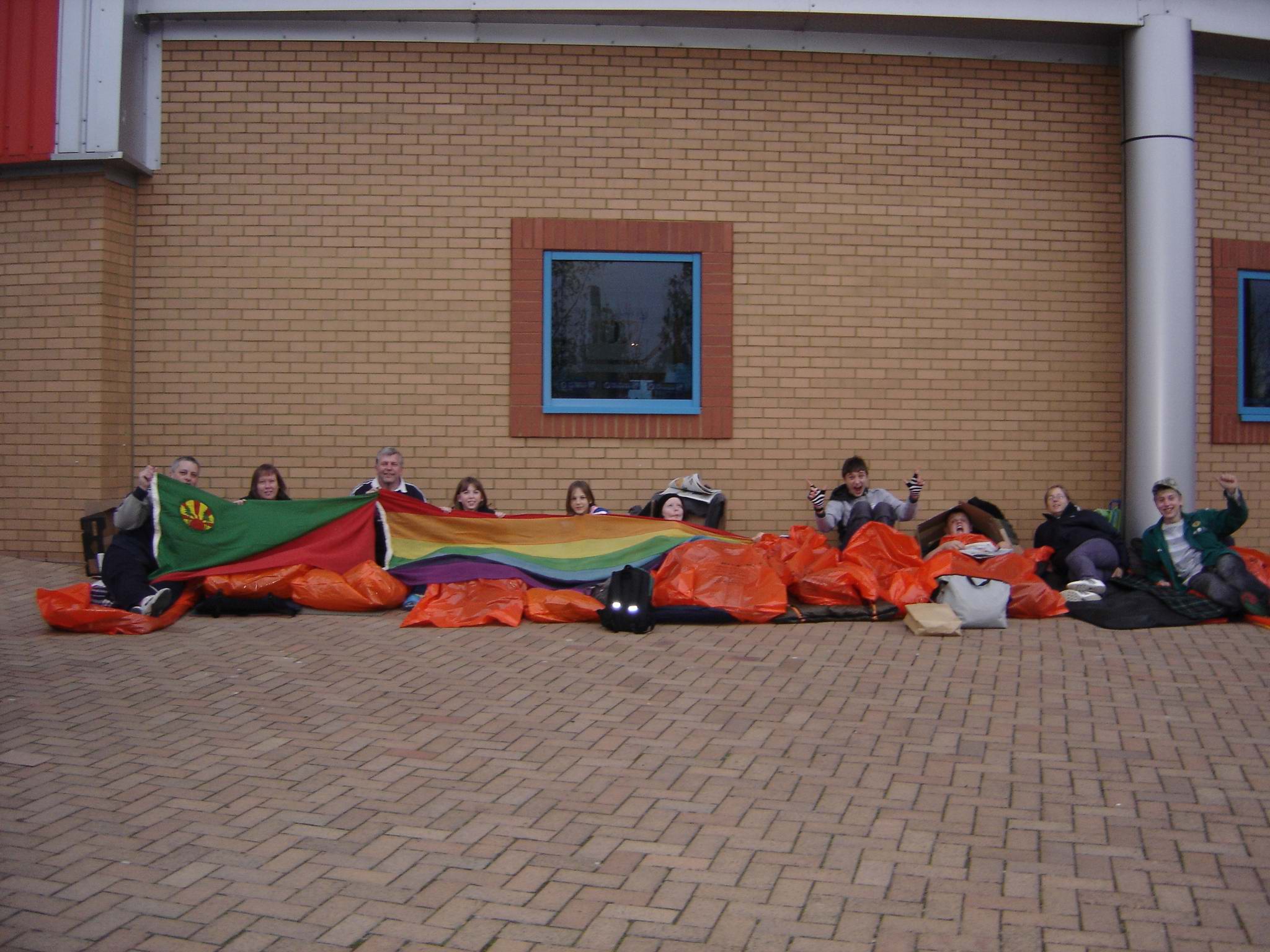 Sleepers in plastic bags with flags